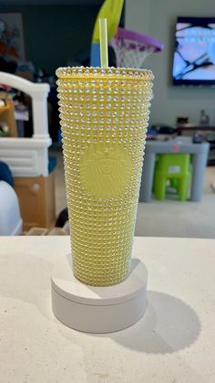 a yellow cup sitting on top of a table