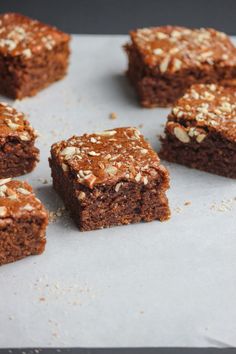 several pieces of brownie sitting on top of a baking sheet