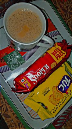 a cup of coffee and some candy on a tray