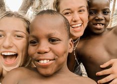 a group of young people standing next to each other with their mouths open and smiling