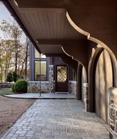 the entrance to a house with stone walkway