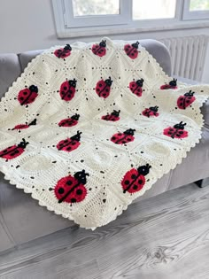 a crocheted ladybug afghan on a couch