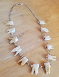 12 genuine human molars hang side by side from sterling silver screws to make up this extremely unique and macabre necklace Tooth Charm, Vial Necklace, Human Teeth, Cute Skeleton, Tooth Necklace, Bone Horn, Charm Necklaces, Leverback Earrings, Beautiful Earrings