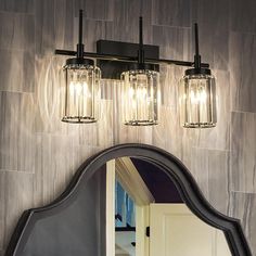 a bathroom vanity with two lights and a mirror