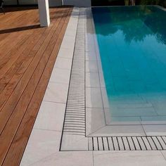 an empty swimming pool in the middle of a wooden deck