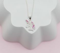 Popular sterling silver unicorn necklace is accented with sparking pink CZs and floats on a 14" Italian chain with high-quality durable lobster clasp. Perfect gift for those girls who love unicorns! This magical unicorn charm is accented with sparkling pink CZs for that bling they love. Matching bracelet and earrings available as well. Perfect gift for your little mystical girl! What a special keepsake gift for toddlers, little girls and children! Necklace comes in beautiful gift box that kids l Pink Cubic Zirconia Jewelry For Birthday, Pink Sterling Silver Necklace With Charms, Hypoallergenic Pink Sterling Silver Necklace, Personalized Pink Sterling Silver Charm Necklaces, Pink Sterling Silver Charm Necklaces, Pink Sterling Silver Personalized Charm Necklace, Personalized Pink Sterling Silver Charm Necklace, Pink Sterling Silver Charm Necklace, Adjustable Pink Sterling Silver Charm Necklaces