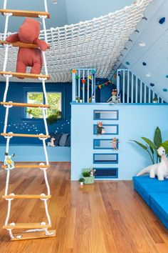 a child's play room with a ladder to the ceiling and toys on the floor