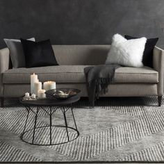 a living room scene with focus on the couch and coffee table in the foreground