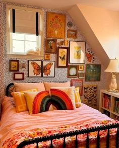 a bed with lots of pictures on the wall above it