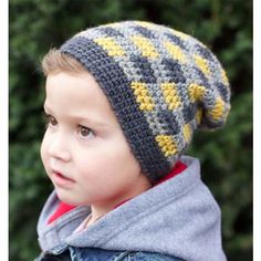 a young boy wearing a gray and yellow knitted hat