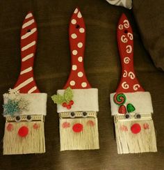 three red and white toothbrush holders decorated with christmas decorations