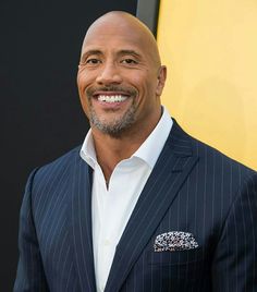 a smiling man in a pinstripe suit and white shirt