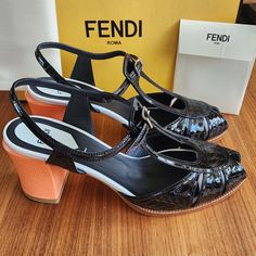 Brand New 100% Authentic Fendi Women's Sandals Featuring Block Heels In Black Color. These Fendi Chameleon Peep Toe Heel Sandals Feature Fendi Logo Script Embossed In Leather, T-Strap, Buckle Closure, And Textured Block Heel (Apprx 3"). Come With Dust Bags And Original Box. Retail $890 Made In Italy. Luxury Orange Heels For Spring, Designer High Heel Orange Sandals, Designer Orange High Heel Sandals, Luxury Orange Evening Sandals, Designer Open Heel Orange Heels, Designer Orange Open Toe Heels, Luxury Orange Patent Leather Heels, Luxury Orange Sandals For Formal Occasions, Designer Orange Sandals With Round Toe