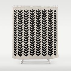 a black and white shower curtain with leaves on it