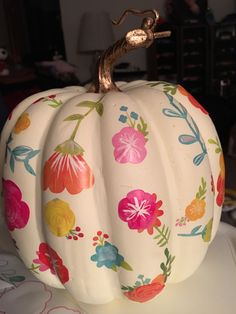 a painted pumpkin sitting on top of a table