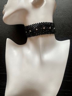 Black onyx beads exquisitely set off the single line of natural pearls in this feminine choker, made using the traditional Masai beading technique using real gemstones Black Faceted Beads Choker, Elegant Adjustable Beaded Choker Necklace, Elegant Beaded Choker, Black Faceted Beads Choker As Gift, Black Choker With Faceted Beads As Gift, Elegant Adjustable Polished Beads Choker, Black Beaded Choker For Evening, Evening Black Bead Choker Necklace, Evening Black Beads Choker Necklace