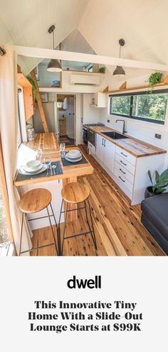 the interior of a tiny home with wooden floors and white walls, is featured in this ad for dwelll