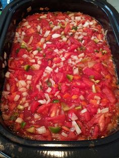 a casserole dish with tomatoes and onions in it