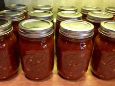 many jars are lined up on a table