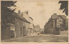 an old black and white photo of a street