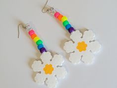 These earrings are made with rainbow pony beads and perler daisy charms. These earrings are lightweight and have fun movement. This Item is premade and is ready to ship. Perfect for any event! You will get lots of compliments in this unique wearable art! Stand out at your next event! Edm festival  Raves Party  Rave outfit  Festival outfit Pride Party favor Birthday gift Stocking stuffer Christmas gift Glow party Rave birthday  Rave gift Cute White Beaded Dangle Earrings, White Rave Jewelry For Gift, Handmade Fun Beaded Earrings For Festivals, Fun White Beaded Earrings, Fun White Flower-shaped Jewelry, Playful White Jewelry For Festival, Playful White Jewelry For Festivals, Playful White Festival Jewelry, Rave Birthday