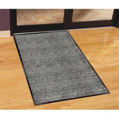 a door mat on the floor in front of a glass door