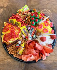 a plate filled with candy and candies on top of a wooden table