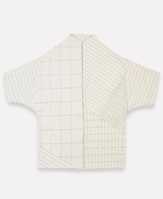 the back of a white shirt with black and white squares on it, which is cut in half