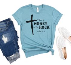 Show off your style this summer wearing this cute There Is Honey In The Rock Tee! ▪️ Please refer to the size chart for sizing  ▪️ Shirts are made using sublimation, which is permanently pressed into the fibers of the shirt  ▪️ Soft & Comfortable Shirts  ▪️ Bella Canvas 52% Cotton / 48% Polyester - Heather Blue Lagoon Care Instructions:  Wash inside out, delicate cycle, lay flat to dry. Check out my shop for more fun items!  https://www.etsy.com/shop/tealcottageboutique Summer Band Merch Shirt With Letter Print, Summer Band Merch Cotton Shirt, Band Merch Cotton Shirt For Summer, Summer Cotton Shirt With Band Merch, Unisex Text Print Shirt For Summer, Summer Unisex Text Print Shirt, Summer Text Print Shirt, Honey In The Rock, Comfortable Shirts