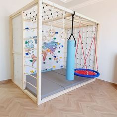 a room with a play area and wallpaper on the walls, including an exercise mat