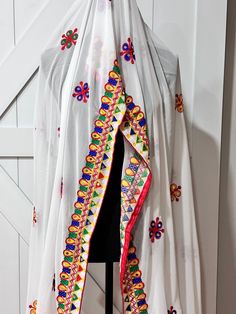 Gorgeous georgette dupatta with mirror and thread work Experience the elegant look and intricate design of our Navaratri Dupatta in white. The perfect combination of georgette fabric with mirror and thread work creates a stunning and luxurious accessory for your traditional outfits. Elevate your style with our high-quality product that adds a touch of sophistication to your Navaratri celebrations. Bohemian Choli With Sheer Dupatta In Chanderi, Bohemian Chanderi Choli With Sheer Dupatta, Bohemian Georgette Choli With Sheer Dupatta, Bohemian Choli With Dupatta In Georgette, Unstitched White Choli With Cutdana, White Unstitched Embroidered Fabric For Navratri, Navratri White Unstitched Embroidered Fabric, White Resham Embroidered Fabric For Navratri, White Embroidered Fabric In Traditional Drape For Navratri