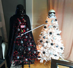 a star wars themed christmas tree next to a darth vader figurine