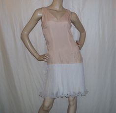 a mannequin wearing a pink and white dress