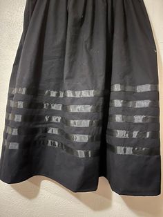 Ribbon skirt - black and black Ribbon Skirt - Skirt has an elastic waist that gives it the elusion of an A-line skirt.  Most skirts are 100% cotton or primarily cotton. Authentic Native American design for Pow Wow and Native American dances.  This skirt is meant to be a mid-calf-length skirt and is typically 31 - 32 inches. If you need it shortened, please let me know. This skirt can be made into a long skirt. If you do not find it on the LONG skirt post please message me for instructions. PLEASE CHOOSE YOUR SIZE BELOW!!  RUSH SHIPPING: If you need to rush your shipping, (anything out of the normal time frame for making your order) please note that I use USPS Priority Mail. You can change the shipping if you need to but please note, you will be charged for it and  I will also ask you to pa Native American Dance, Ribbon Skirt, Black And Black, Ribbon Skirts, Calf Length Skirts, Ankle Length Skirt, Native American Design, Pow Wow, Skirt Fits