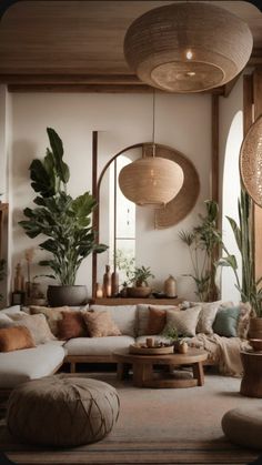 a living room filled with lots of furniture and plants