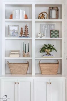 a white bookcase with baskets and books on it