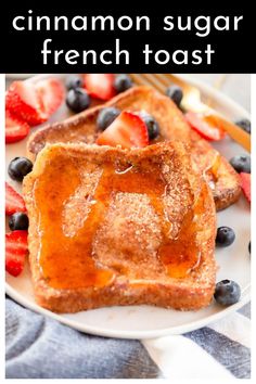 french toast on a white plate with strawberries and blueberries in the background text reads cinnamon sugar french toast