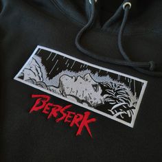 a black hoodie with an image of a demon on the front and red lettering that says bersek