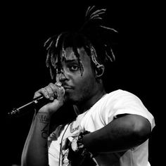 a man with dreadlocks holding a microphone