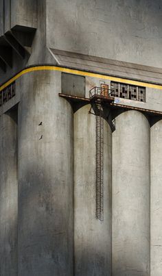 an airplane is flying through the air over some concrete pillars and buildings with windows on them