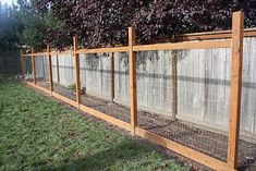 a fence that is made out of wood and wire with plants growing on top of it