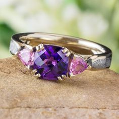 three different colored stones on top of a rock