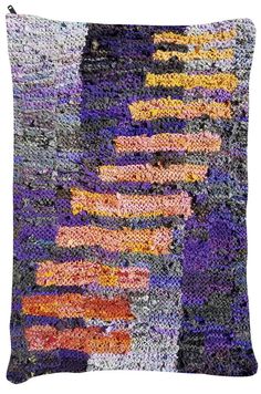 an abstract piece of art made out of different colored yarns and fabric, with multiple colors