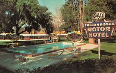 a painting of a motel sign next to a pool with chairs and umbrellas around it