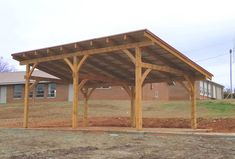 a large wooden structure sitting on top of a dirt field