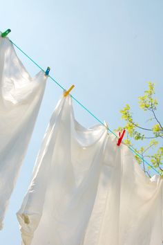 three white cloths hanging from a clothes line