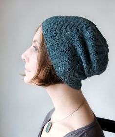 a woman wearing a green knitted hat