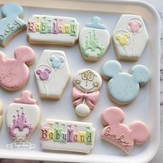 decorated cookies in the shape of mickey and minnie mouses for a baby's first birthday