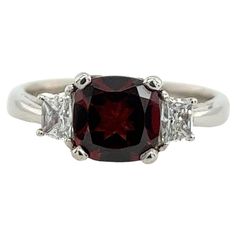 An elegant and unique 1.88ct garnet and diamond ring, set with 2 tapered natural diamonds 0.33ct, in a platinum beautiful setting. Width of Band: 3.05mm Width of Head: 7.47mm Length of Head: 13.53mm Total Weight: 6.10g Ring Size: M SMS9233 Garnet And Diamond Ring, Diamond Ring Set, Diamond Ring Settings, Three Stone Rings, Three Stone, Ring Set, Ring Sets, Natural Diamonds, Garnet