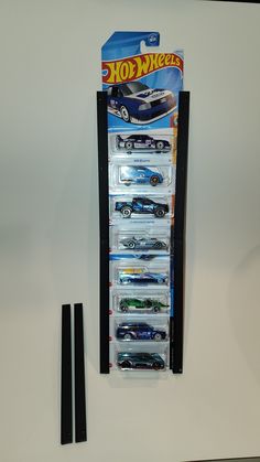 the hot wheels display case has six cars in it